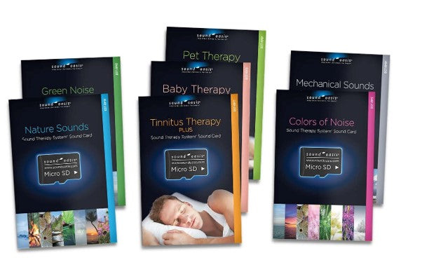 Five boxed sound therapy card kits arranged on a white background, including Nature Sounds, Baby Therapy, Pet Therapy, Tinnitus Therapy Plus, and Colors of Noise. The boxes are dark with colorful side panels and small imagery along the bottom.
